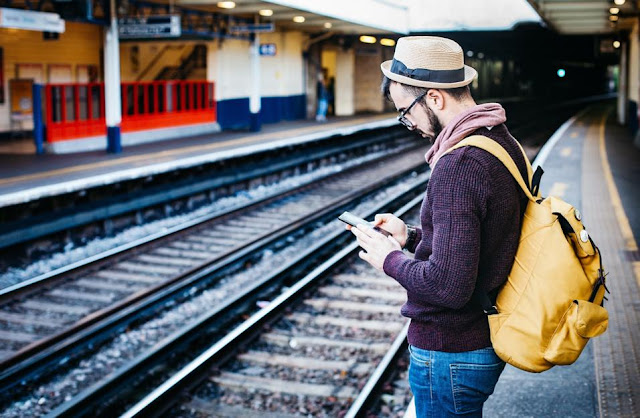 Man with backpack waiting at the train station